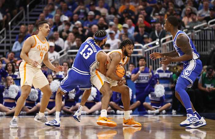 Tennessee Volunteers guard Josiah-Jordan James wrestles for the ball with Duke Blue Devils guard Jacob Grandison.